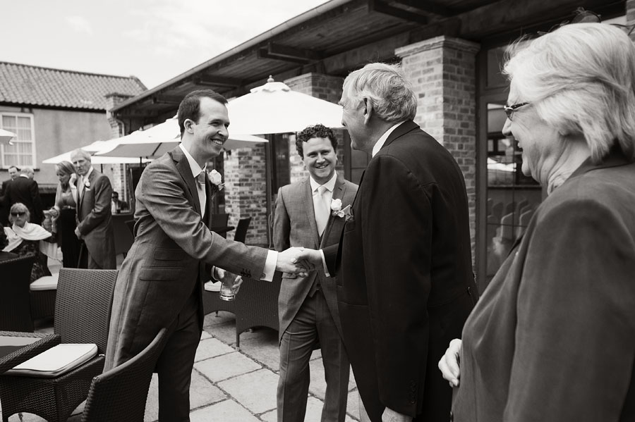 Groom greets a guest