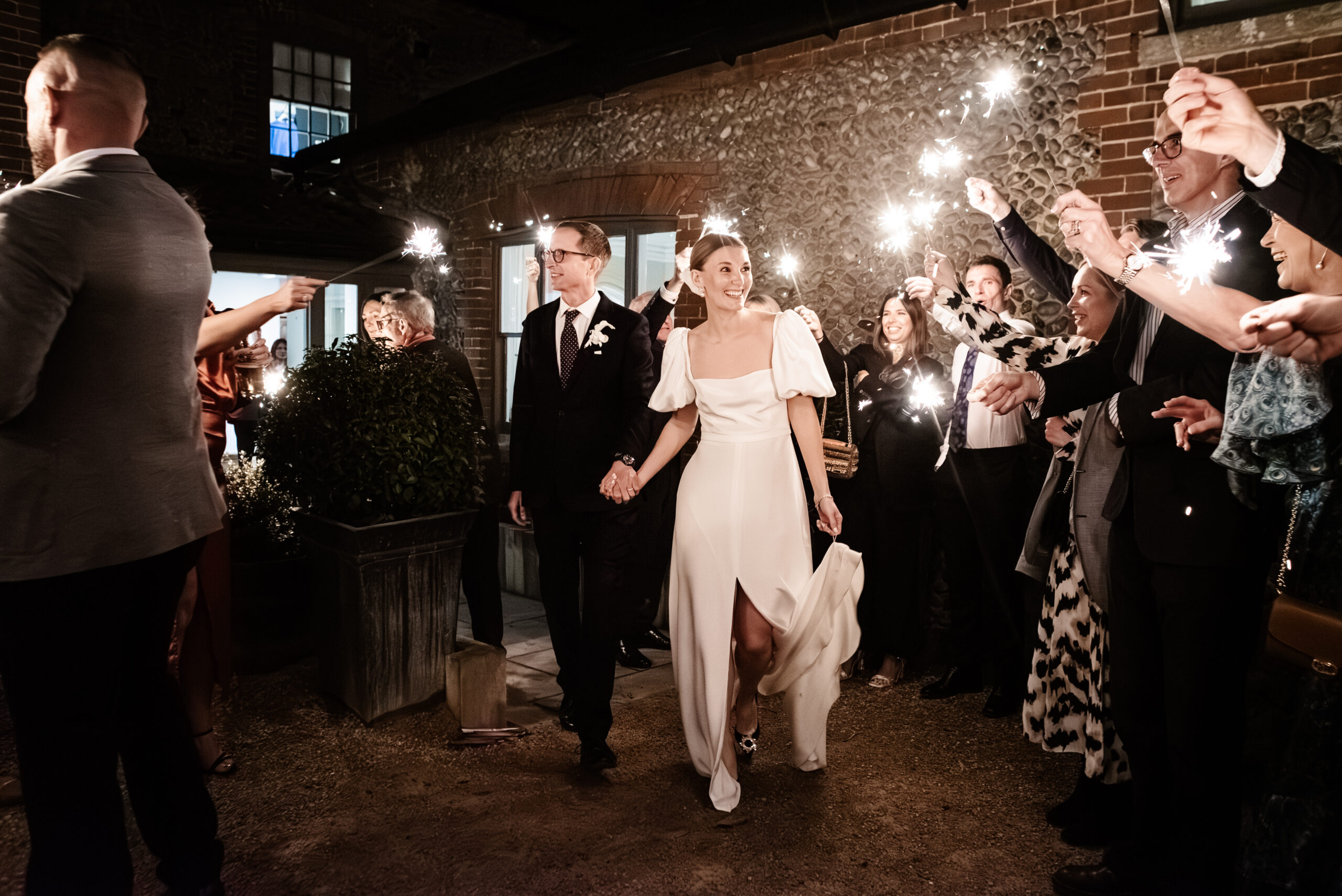 Newlyweds are celebrated by their guests with sparklers